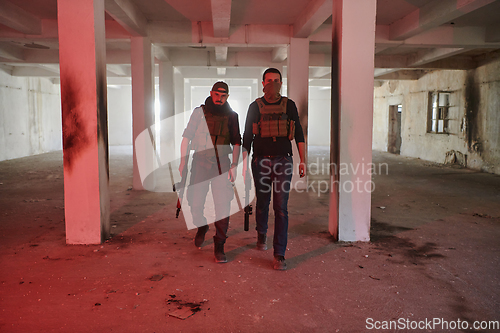 Image of An abandoned building serves as the stronghold for a team of terrorists, fiercely guarding their occupied territory with guns and military equipment