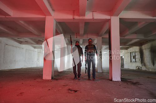 Image of An abandoned building serves as the stronghold for a team of terrorists, fiercely guarding their occupied territory with guns and military equipment