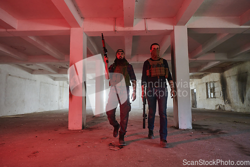 Image of An abandoned building serves as the stronghold for a team of terrorists, fiercely guarding their occupied territory with guns and military equipment