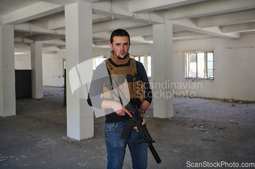 Image of Modern warfare soldier portrait in urban environment