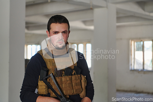 Image of Modern warfare soldier portrait in urban environment