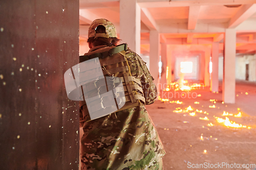 Image of A group of professional soldiers bravely executes a dangerous rescue mission, surrounded by fire in a perilous building.