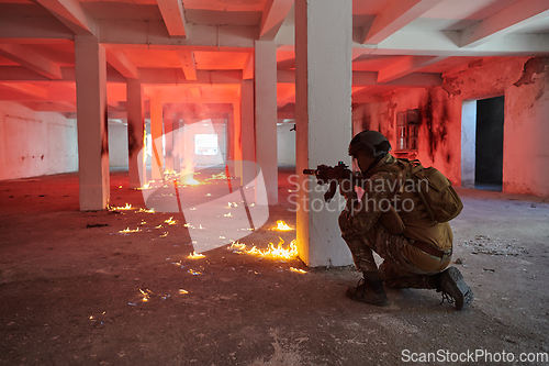 Image of A group of professional soldiers bravely executes a dangerous rescue mission, surrounded by fire in a perilous building.