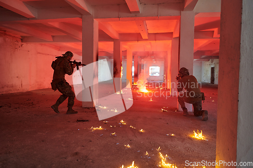 Image of A group of professional soldiers bravely executes a dangerous rescue mission, surrounded by fire in a perilous building.