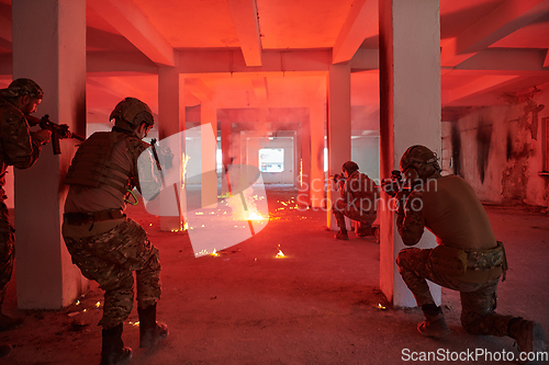 Image of A group of professional soldiers bravely executes a dangerous rescue mission, surrounded by fire in a perilous building.