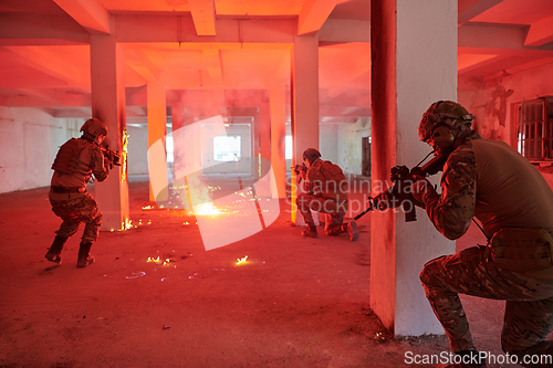 Image of A group of professional soldiers bravely executes a dangerous rescue mission, surrounded by fire in a perilous building.