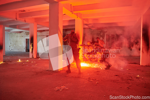 Image of A group of professional soldiers bravely executes a dangerous rescue mission, surrounded by fire in a perilous building.