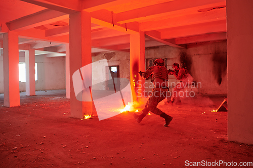 Image of A group of professional soldiers bravely executes a dangerous rescue mission, surrounded by fire in a perilous building.