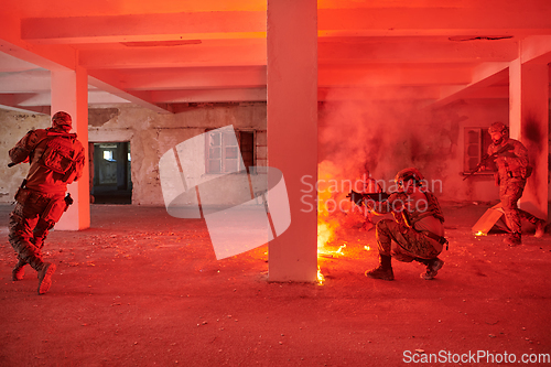 Image of A group of professional soldiers bravely executes a dangerous rescue mission, surrounded by fire in a perilous building.