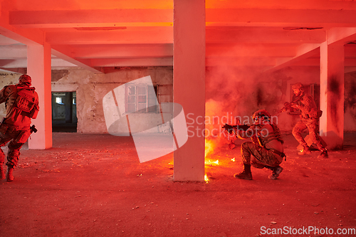 Image of A group of professional soldiers bravely executes a dangerous rescue mission, surrounded by fire in a perilous building.