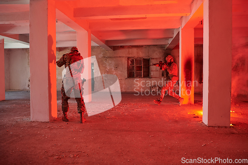 Image of A group of professional soldiers bravely executes a dangerous rescue mission, surrounded by fire in a perilous building.