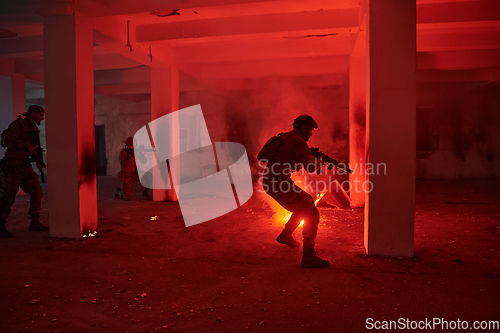 Image of A group of professional soldiers bravely executes a dangerous rescue mission, surrounded by fire in a perilous building.