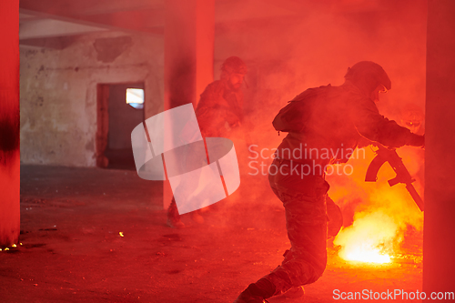 Image of A group of professional soldiers bravely executes a dangerous rescue mission, surrounded by fire in a perilous building.