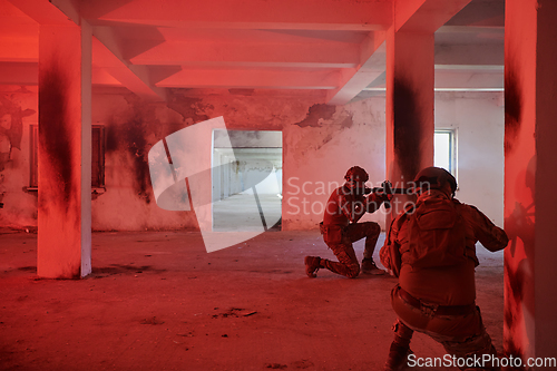 Image of A group of professional soldiers bravely executes a dangerous rescue mission, surrounded by fire in a perilous building.