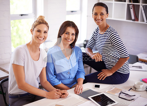 Image of Making a success of their start-up business. Three confident young businesswomen smiling at the camera.