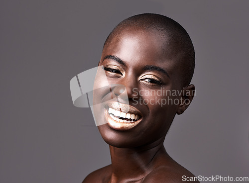 Image of Laughter is the cheapest medicine. A beautiful woman smiling happily while standing in a studio.