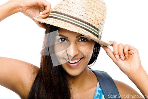 Image of She never leaves home without her hat. a young woman posing against a studio background.