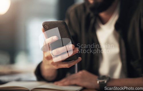 Image of The make it hAPPen device. an unrecognisable businessman using a smartphone during a late night at work.