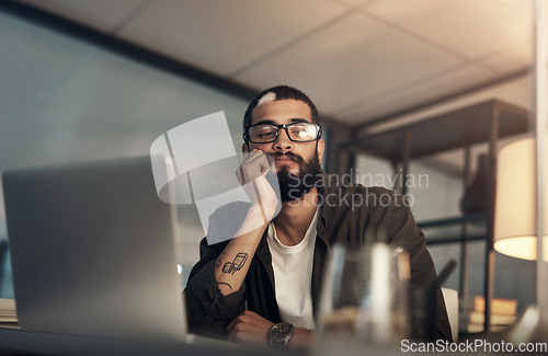 Image of Are long working hours making me miss out on life. a young businessman looking uncertain while working late at night in a modern office.