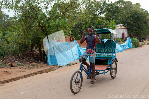 Image of Traditional rickshaw on the city streets. Rickshaws are a common mode of transport in Madagascar.