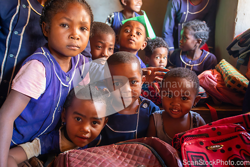 Image of Happy Malagasy school children students in classroom. School attendance is compulsory, but many children do not go to school.