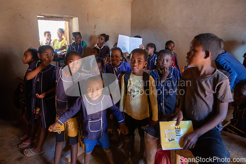 Image of Happy Malagasy school children students in classroom. School attendance is compulsory, but many children do not go to school.