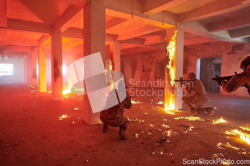 Image of A group of professional soldiers bravely executes a dangerous rescue mission, surrounded by fire in a perilous building.