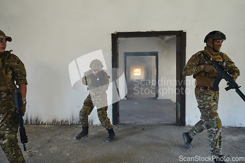 Image of A group of professional soldiers bravely executes a dangerous rescue mission, surrounded by fire in a perilous building.