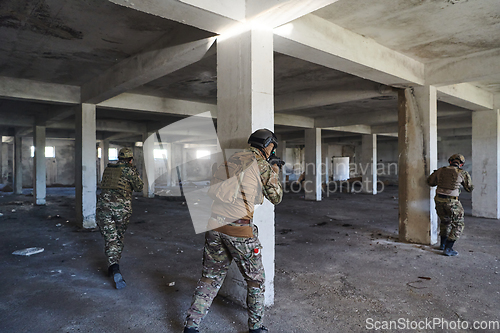 Image of A group of professional soldiers bravely executes a dangerous rescue mission, surrounded by fire in a perilous building.