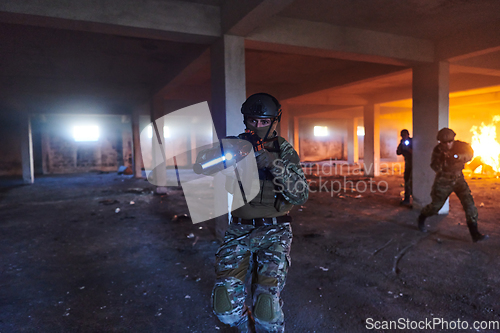 Image of A group of professional soldiers bravely executes a dangerous rescue mission, surrounded by fire in a perilous building.