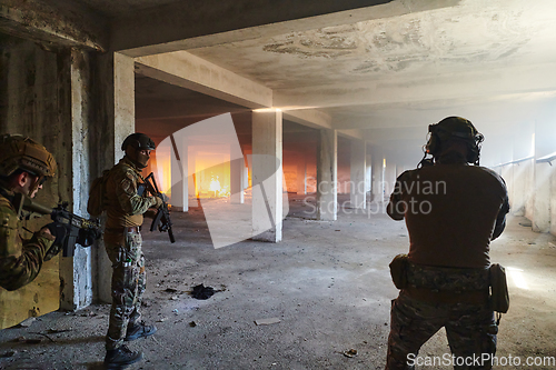 Image of A group of professional soldiers bravely executes a dangerous rescue mission, surrounded by fire in a perilous building.