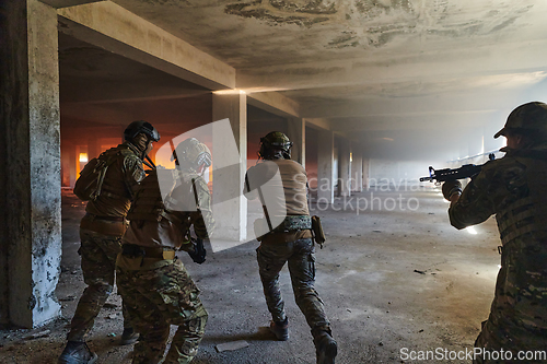 Image of A group of professional soldiers bravely executes a dangerous rescue mission, surrounded by fire in a perilous building.