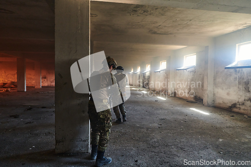 Image of A group of professional soldiers bravely executes a dangerous rescue mission, surrounded by fire in a perilous building.