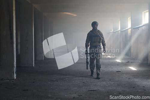 Image of A professional soldier in an abandoned building shows courage and determination in a war campaign