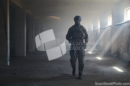 Image of A professional soldier in an abandoned building shows courage and determination in a war campaign