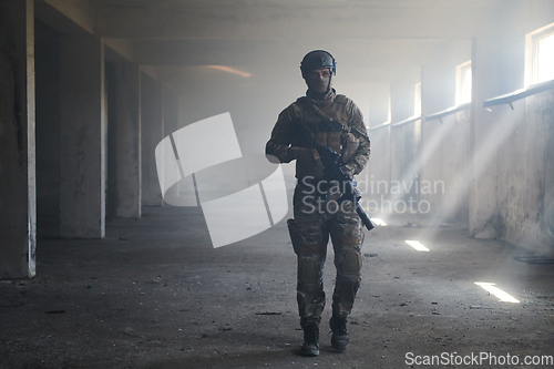 Image of A professional soldier in an abandoned building shows courage and determination in a war campaign
