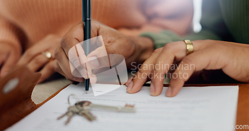Image of Closeup, hands and signature on mortgage paperwork for finance, home contract or a loan. Investment, legal and a couple writing on a document for keys of a house, ownership and agreement for a deal