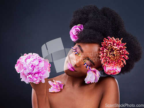 Image of Substitute synthetic chemicals with flower and plant extracts. Studio shot of a beautiful young woman posing with flowers in her hair.
