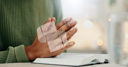 Image of Home, closeup and person with hands, praying and bible with faith, guidance and religion. Zoom, man and guy with holy book, scripture or prayer with spirit, believe or Christian with worship or peace