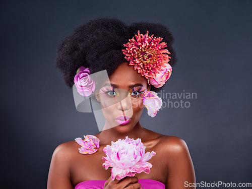 Image of I just cant help but to love flowers. Studio shot of a beautiful young woman posing with flowers in her hair.