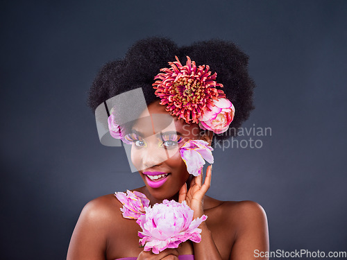 Image of Forget neutral, add a pop of colour. Studio shot of a beautiful young woman posing with flowers in her hair.