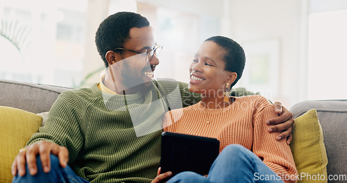 Image of Hug, home tablet and black couple happy for social media post, morning wellness blog or relationship romance. Living room sofa, eye contact and African man, woman or marriage people embrace for love