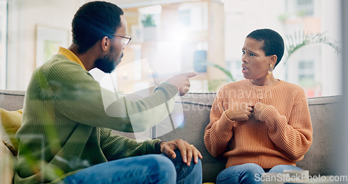 Image of Fight, couple and home with marriage problem, frustrated and angry man on a living room sofa. Mistake, yelling and conversation of people with argument, fail and conflict with divorce discussion