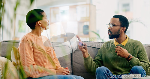 Image of Fight, couple and home with marriage stress, frustrated and angry man on a living room sofa. Mistake, yelling and conversation of people with argument, fail and conflict with divorce discussion