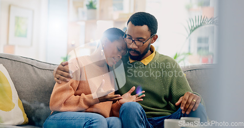 Image of Sad, home and black couple with hug, conversation and emotions with discussion, grief and loss. People, apartment and man with woman, embrace or talking with reaction, crying and support with anxiety