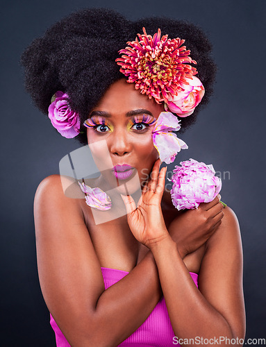 Image of Everyone is talking about how good I look. Studio shot of a beautiful young woman posing with flowers in her hair.