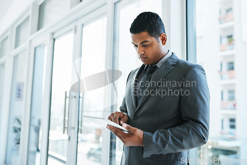 Image of The best device for those on demand tasks. a young businessman using a digital tablet in a modern office.