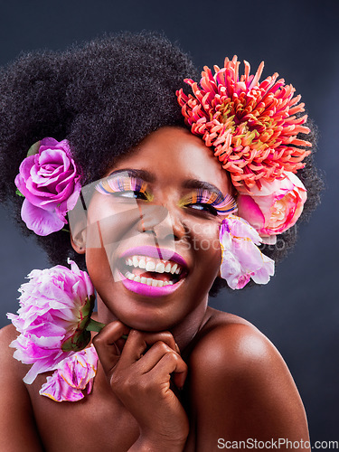 Image of Flowers have many powers beyond beauty and emotions. Studio shot of a beautiful young woman posing with flowers in her hair.