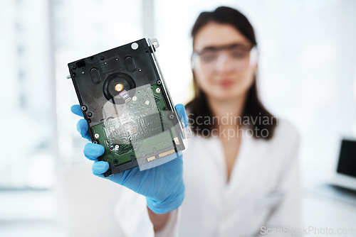 Image of Repaired and ready for use. a young woman repairing computer hardware in a laboratory.