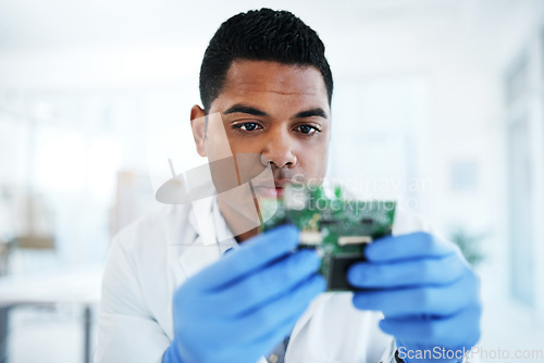 Image of The savant in IT system maintenance. a young man repairing computer hardware in a laboratory.